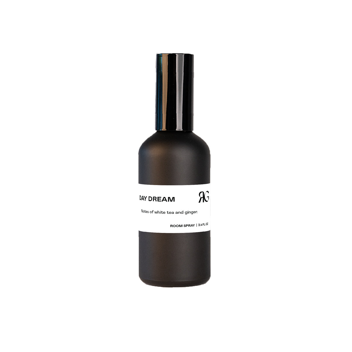 Day Dream Room Spray comes in a matte black bottle with a white band label and black text, offering an uplifting white tea and ginger scent. Its sleek design is ideal for refreshing any room.