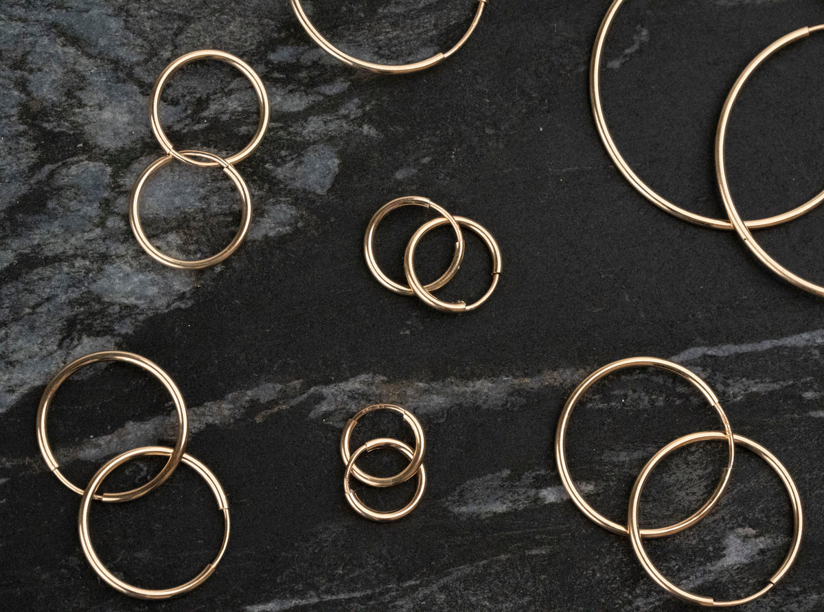 Gold endless hoop earrings with a seamless circular design