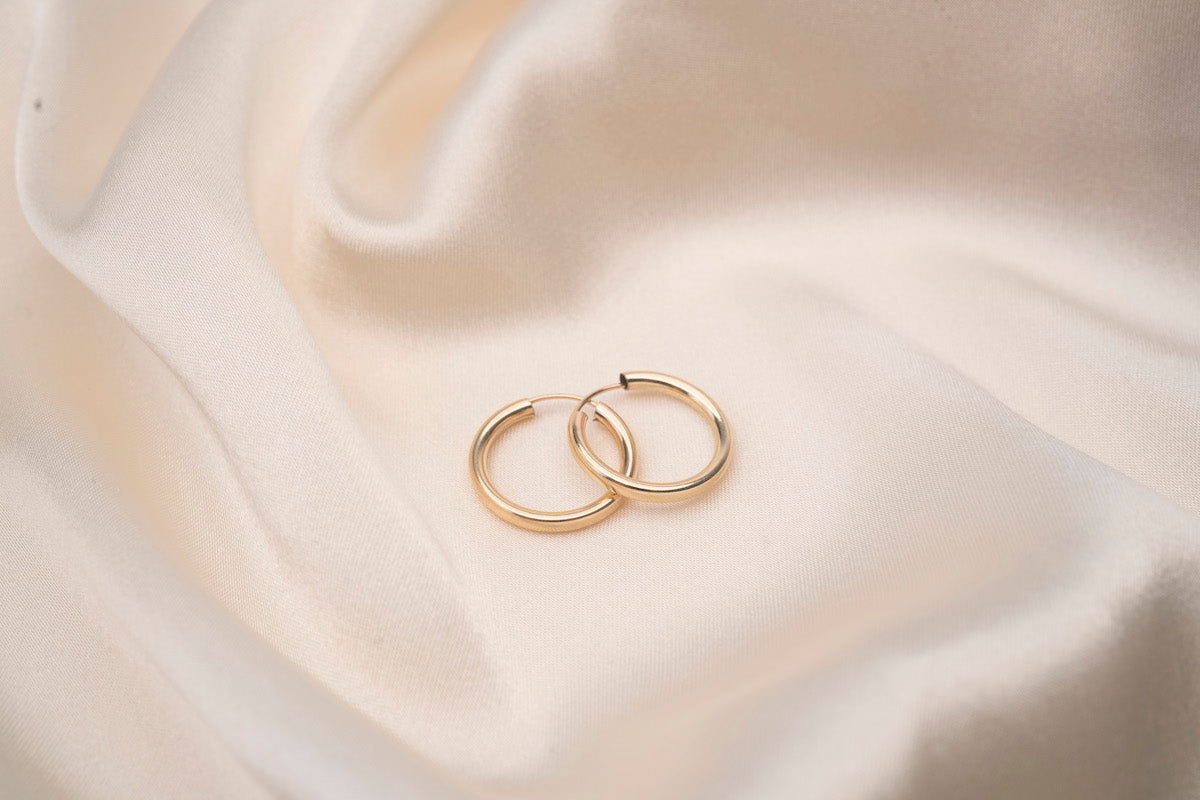 Polished gold endless hoops showing smooth continuous design
