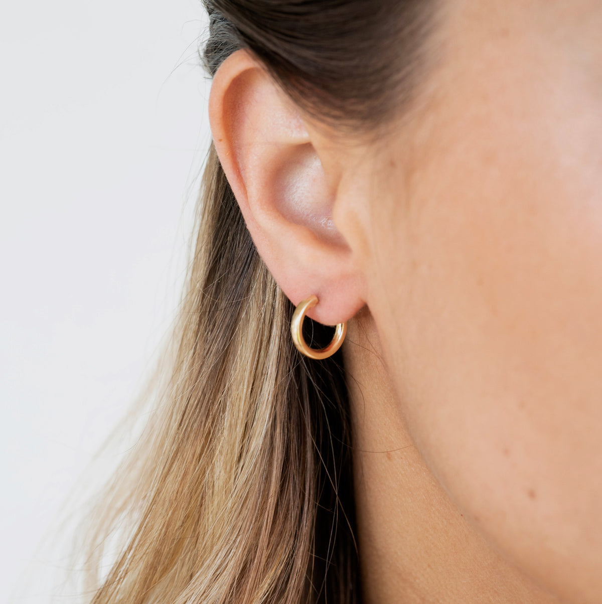 Polished gold endless hoops showing smooth continuous design