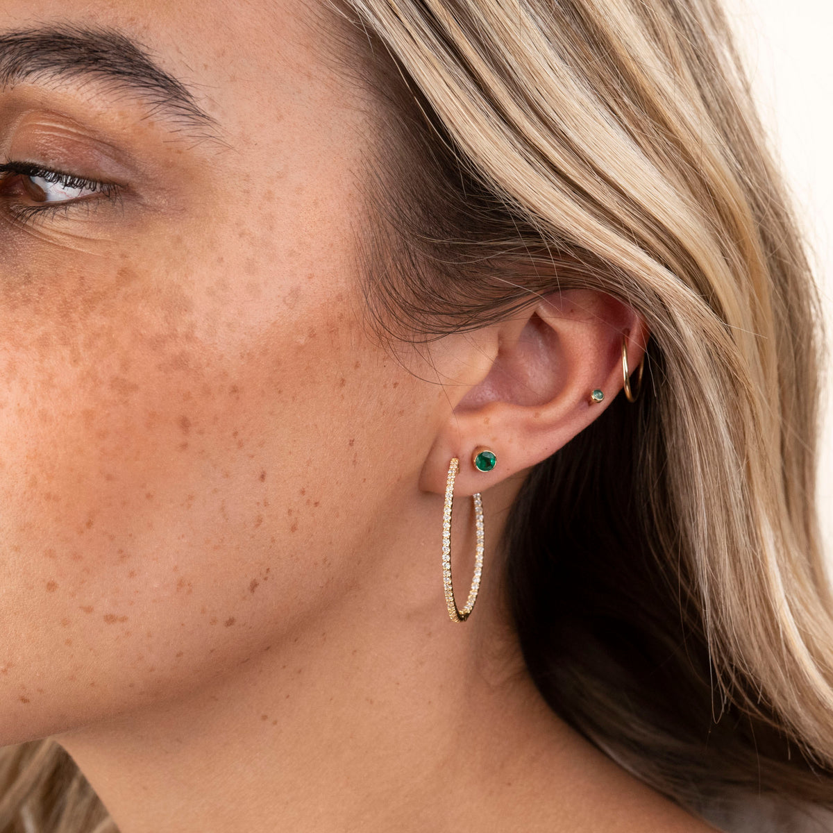 Gold endless hoop earrings with a seamless circular design