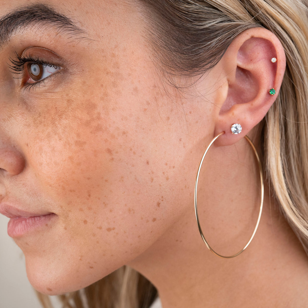 Gold endless hoop earrings with a seamless circular design