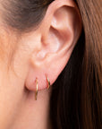 Gold endless hoop earrings with a seamless circular design