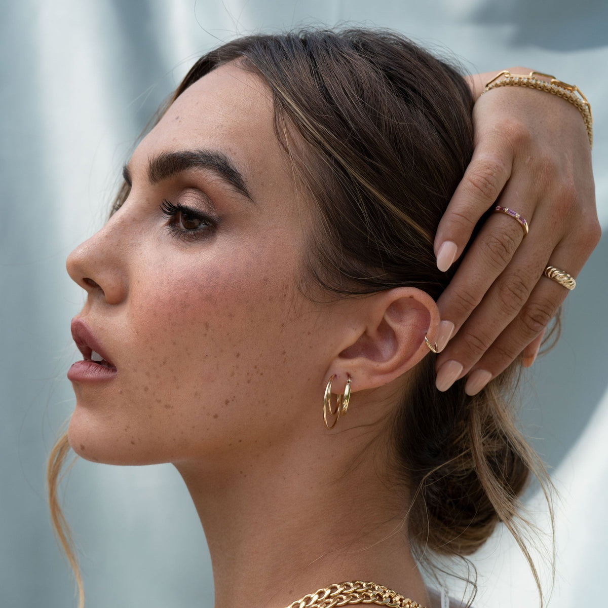 Gold endless hoop earrings with a seamless circular design