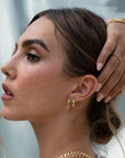 Gold endless hoop earrings with a seamless circular design